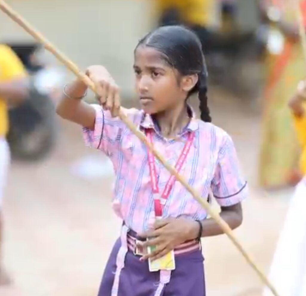 A school girl doing silambam
